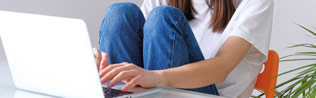 a student typing on a laptop