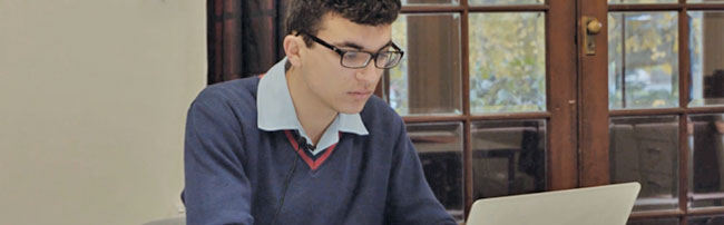 a student studying with an open laptop