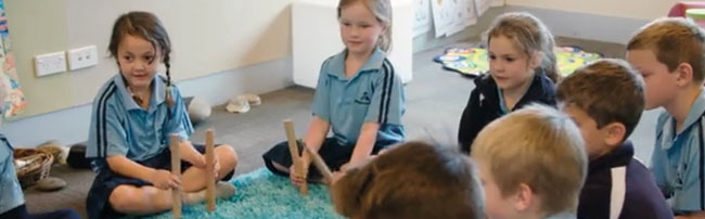 Students playing with rakau on the mat