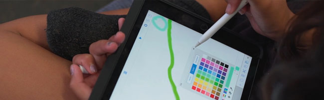 a student drawing on an iPad