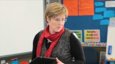 Teacher, Julia Hinman holding an iPad