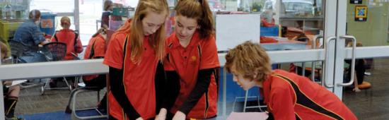 Three students working together at a table