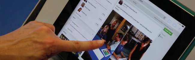 A hand using a digital portfolio on an ipad