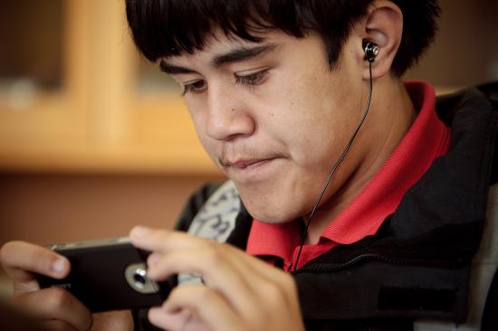 Student using headphones and digital device