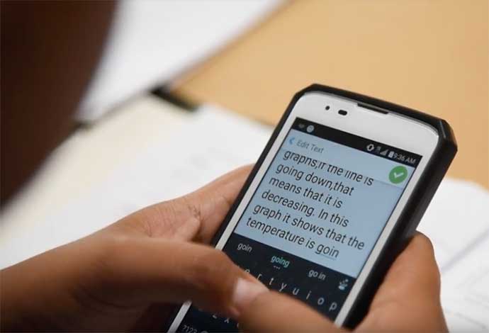 Hands typing a message onto a phone