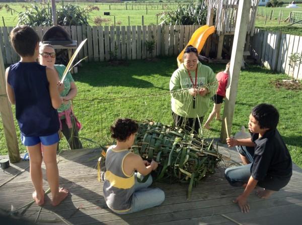 Students and whānau weaving a hinaki